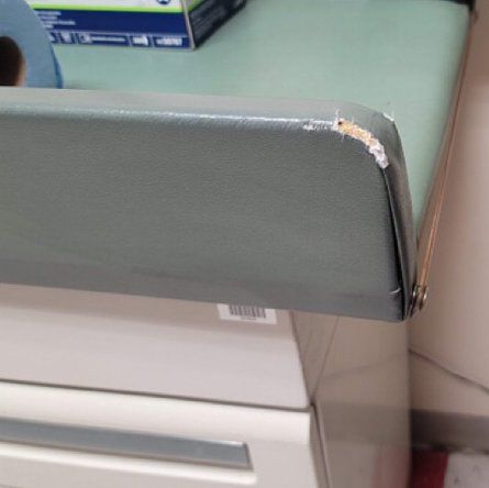 A person is sitting at a desk with a box of gloves on it