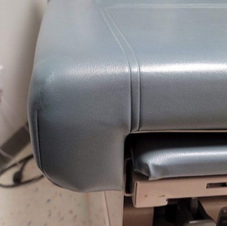A close up of a blue printer sitting on a table.