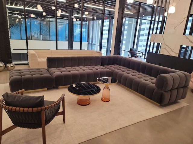 A living room with a large sectional couch and a coffee table