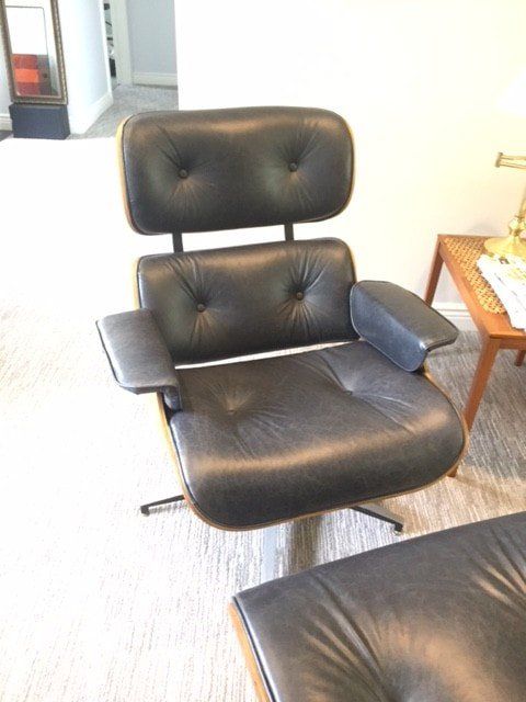 A black leather chair and ottoman in a living room