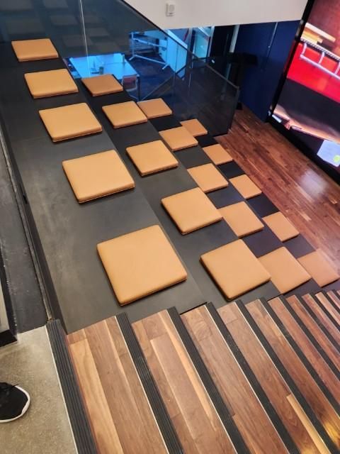 A set of stairs with square cushions on them