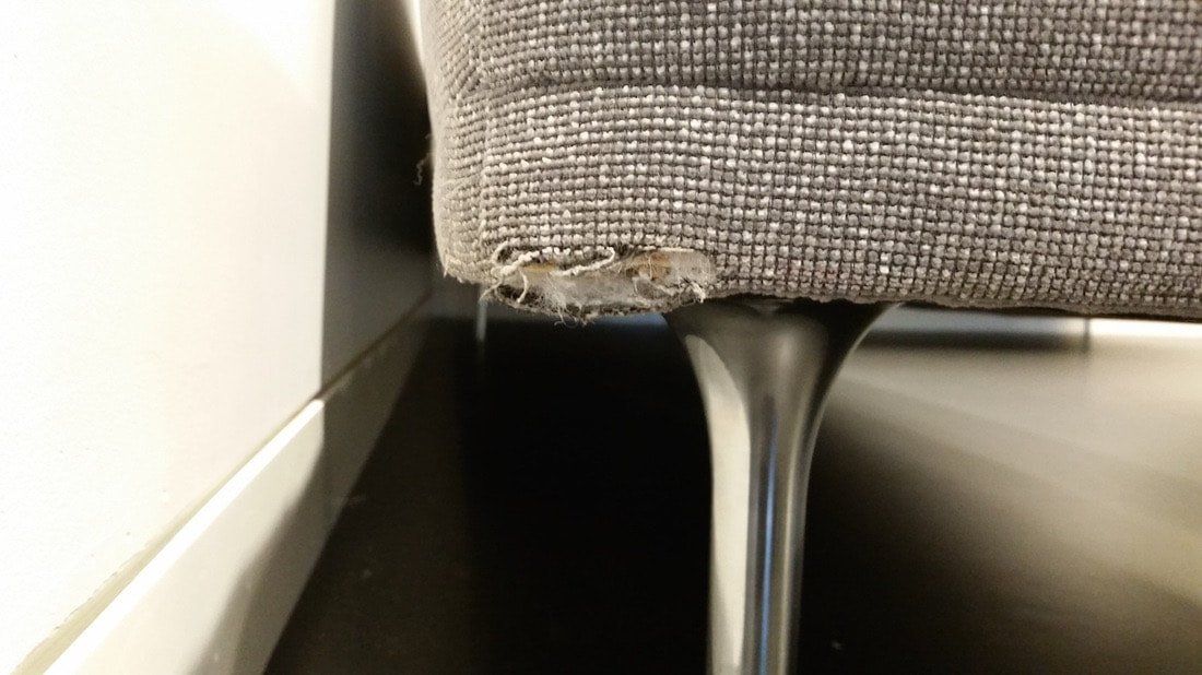 A close up of a chair with a hole in it.