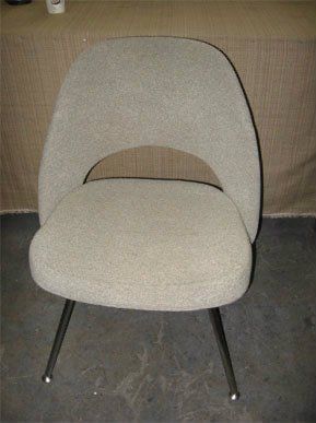 A chair is sitting on a concrete floor in front of a table
