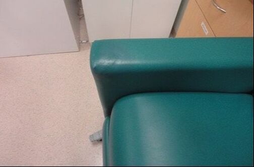 A close up of a green chair 's arm rest