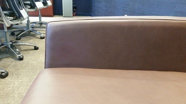 A brown chair is sitting in a room with other chairs