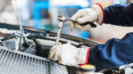 Hand of repair man repairing engine of a car — Auto spares and wrecking services in Winnellie NT, 0821