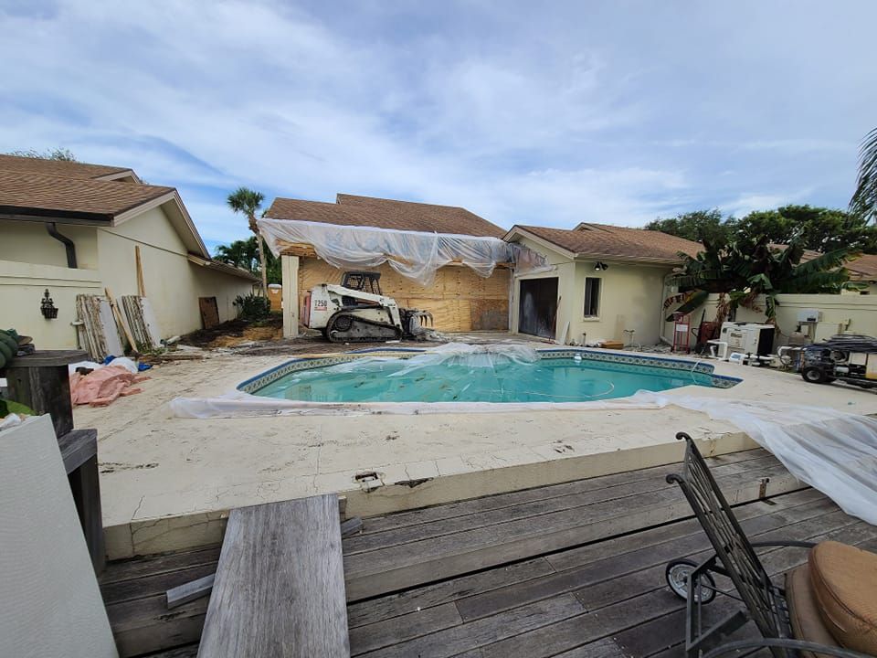 A swimming pool is being built in the backyard of a house.
