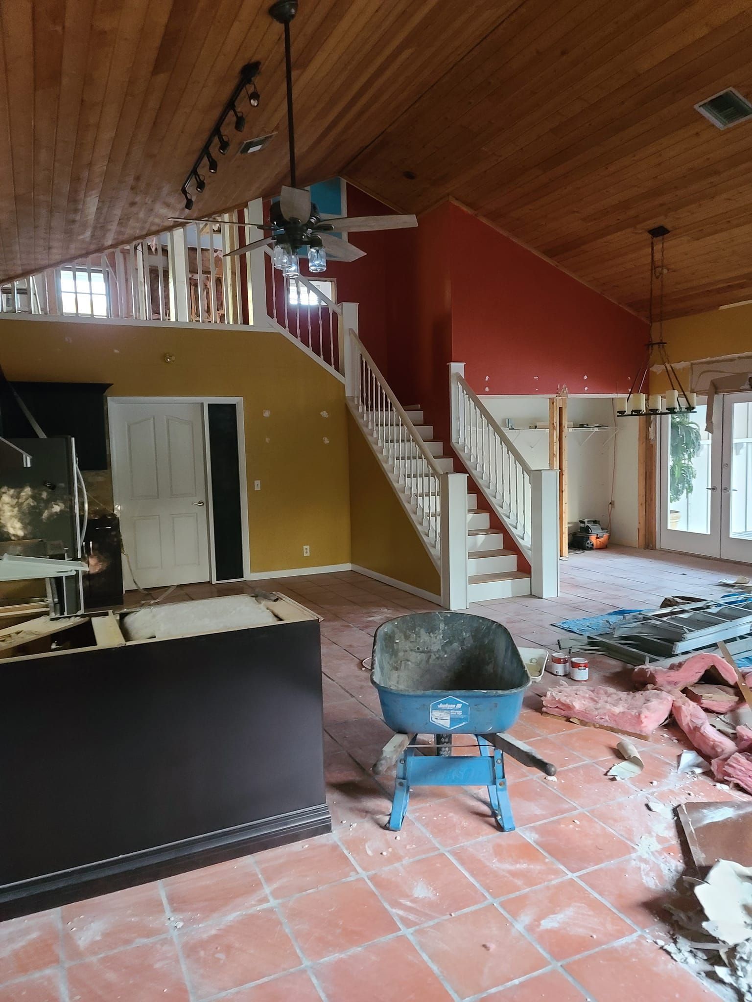 A large room with a wheelbarrow in the middle of it