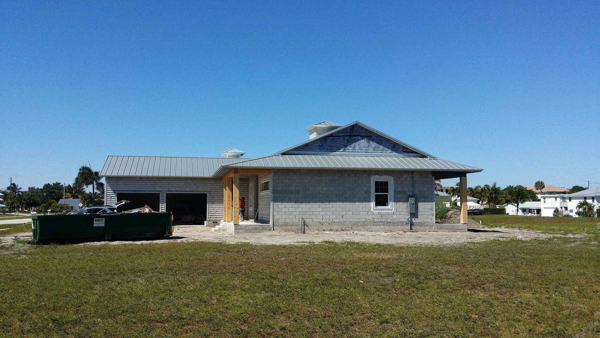 A house is being built in a grassy field.