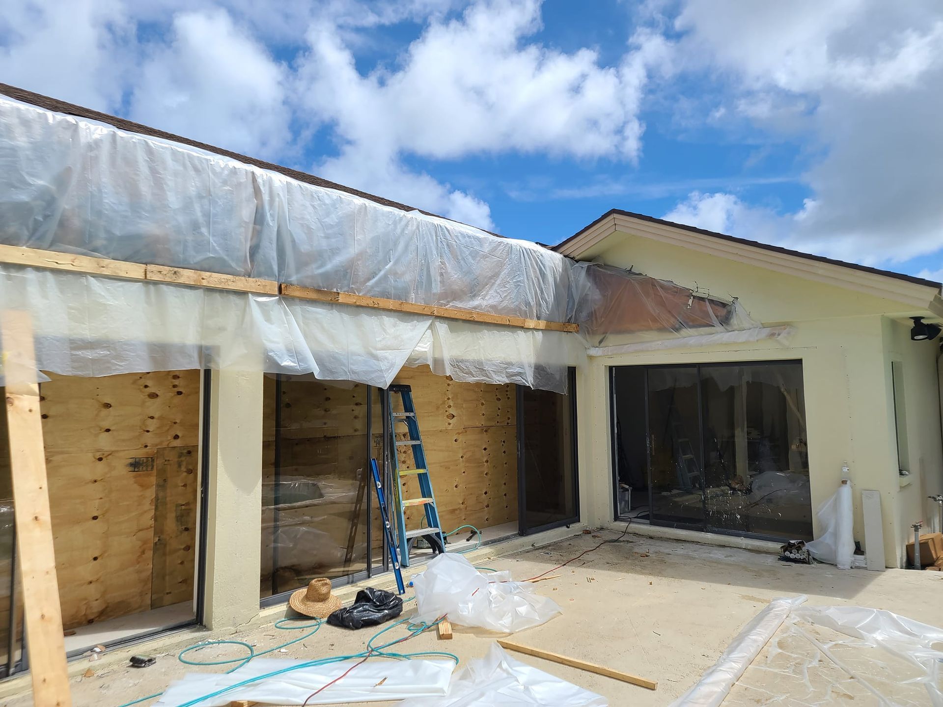A house is being remodeled and covered in plastic.