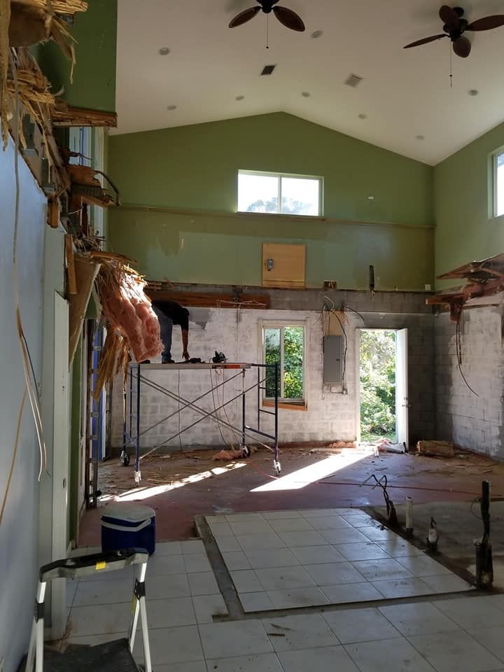 A large room with scaffolding and a ceiling fan
