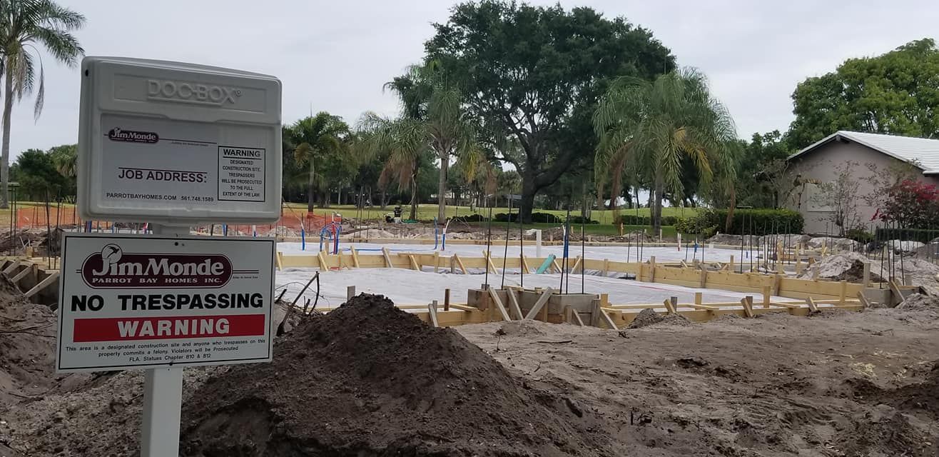 A construction site with a sign that says no trespassing warning