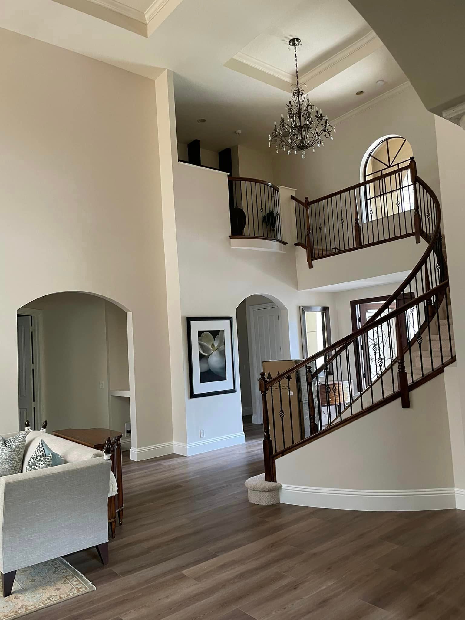 A living room with a staircase leading up to the second floor.