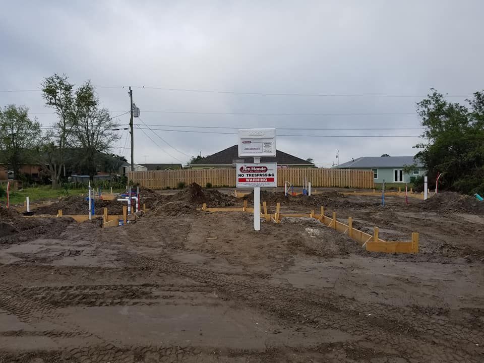 A construction site with a for sale sign in the middle of it.