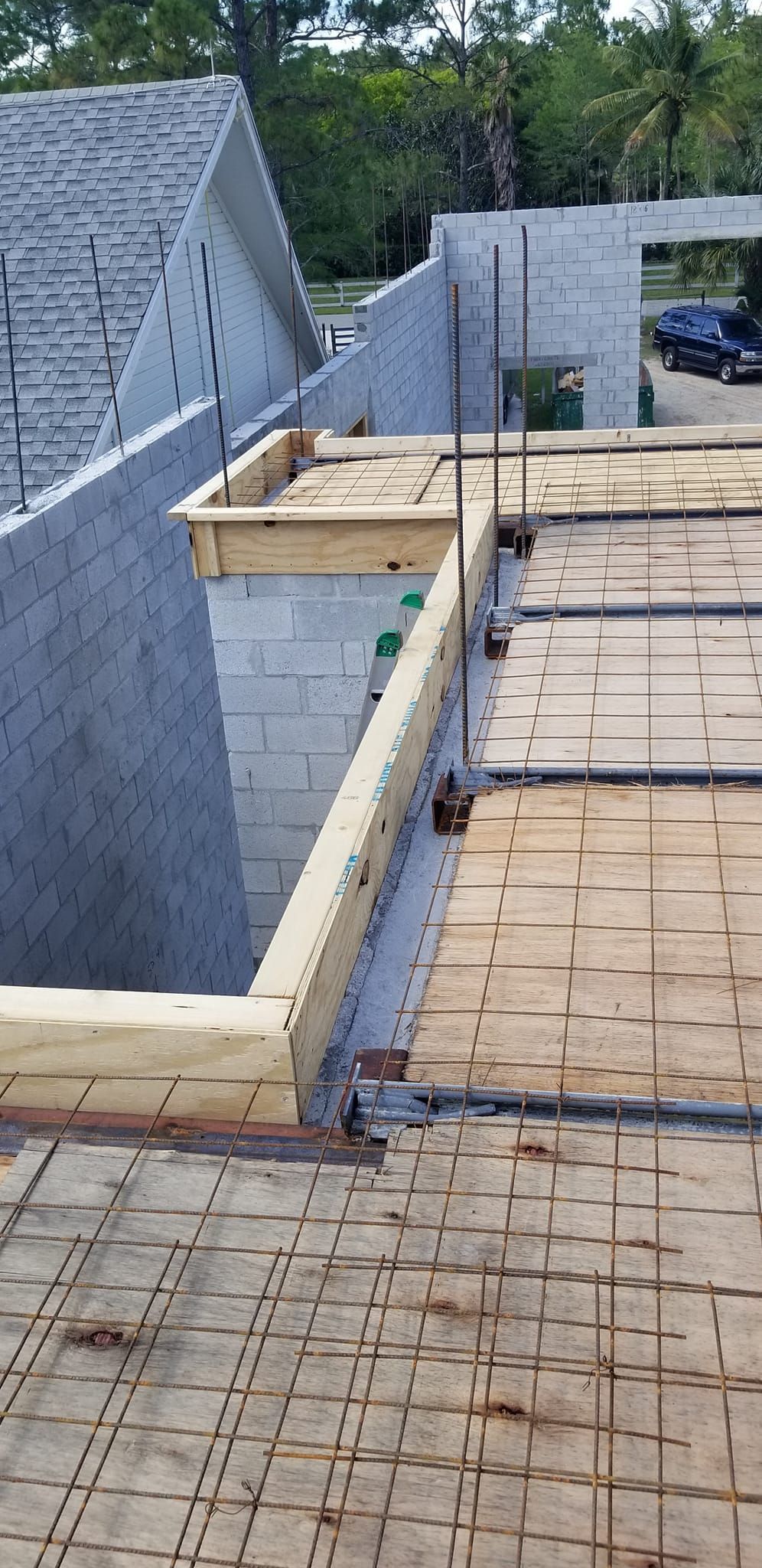 A wooden deck is being built on the side of a building.
