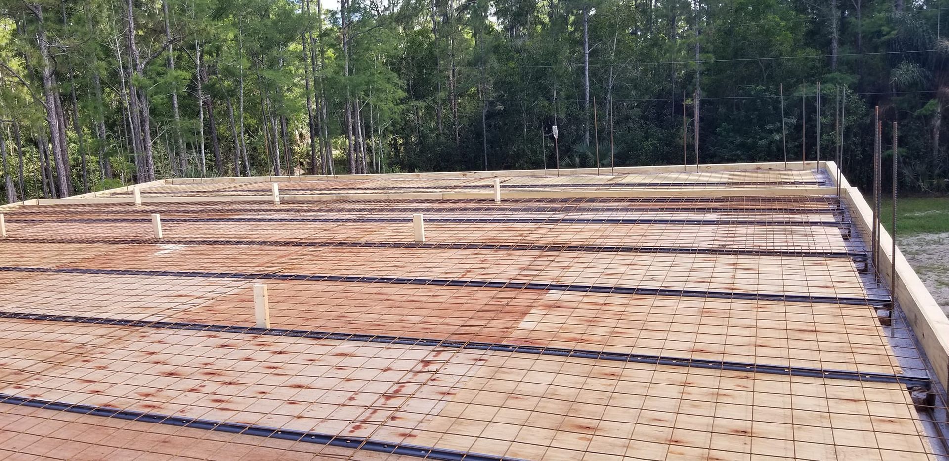 A wooden roof with a lot of holes in it is being built.