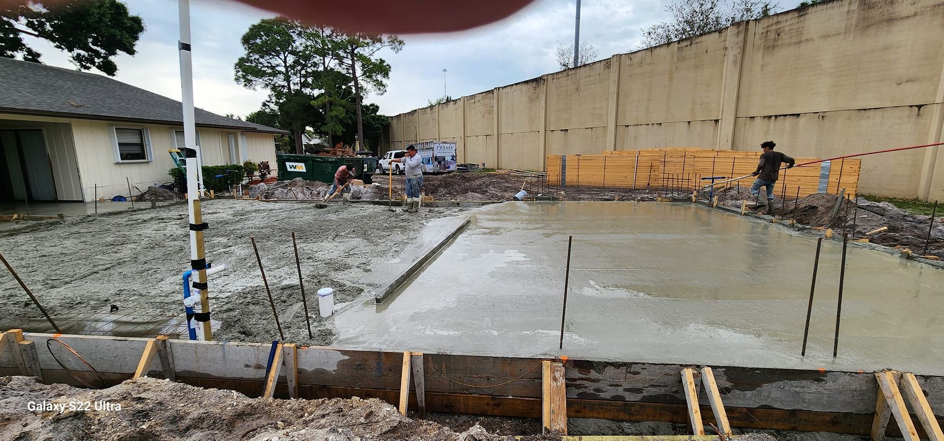 A person is holding a piece of concrete in their hand.