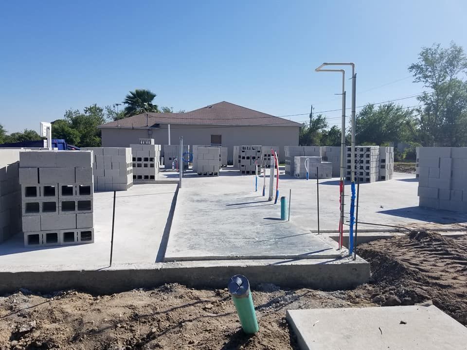 A construction site with a house in the background