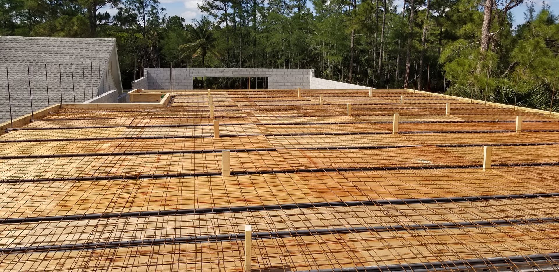 A roof of a building under construction with trees in the background.