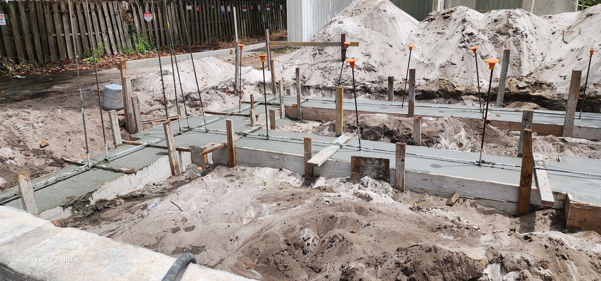 A construction site with a lot of dirt and concrete.