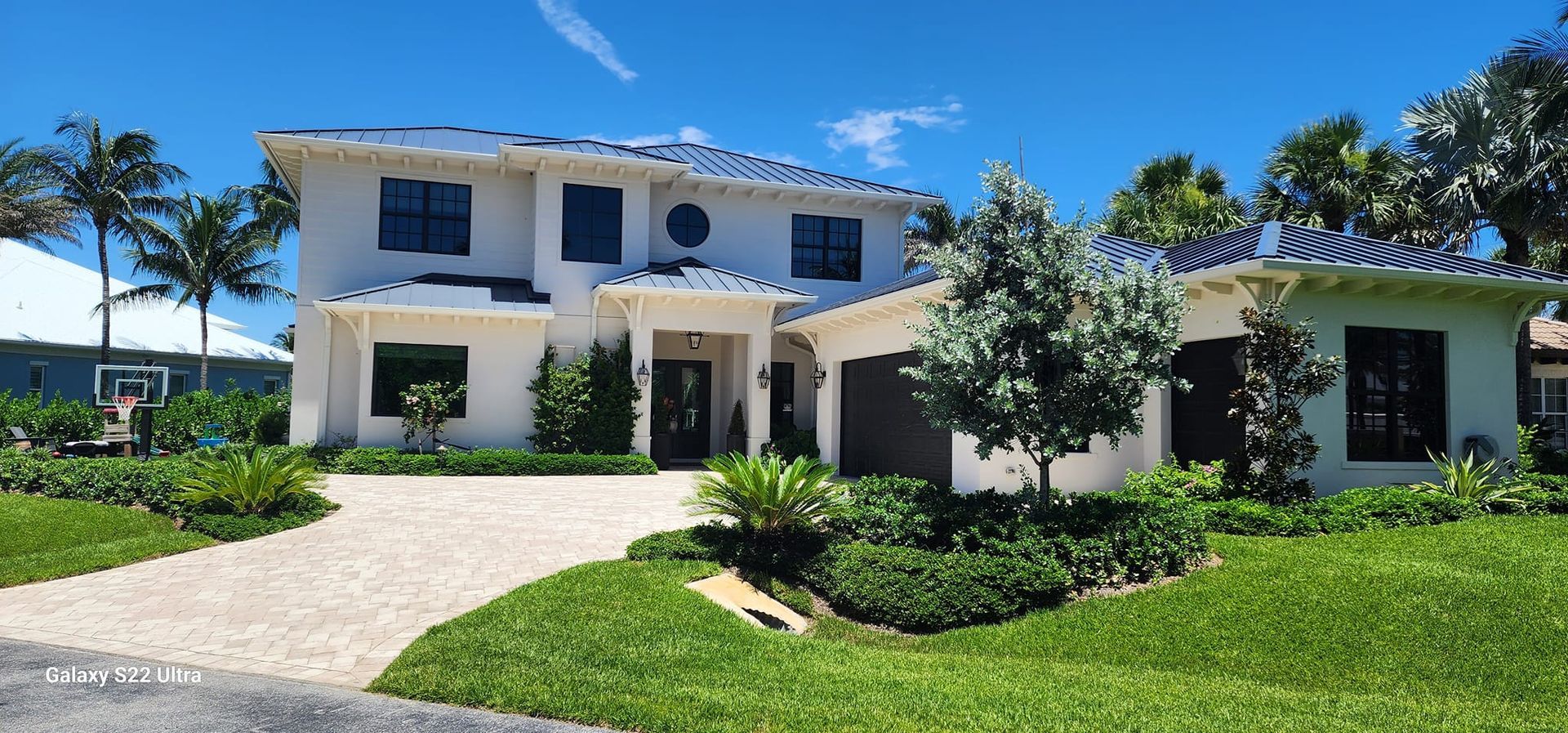 A large white house with a driveway leading to it