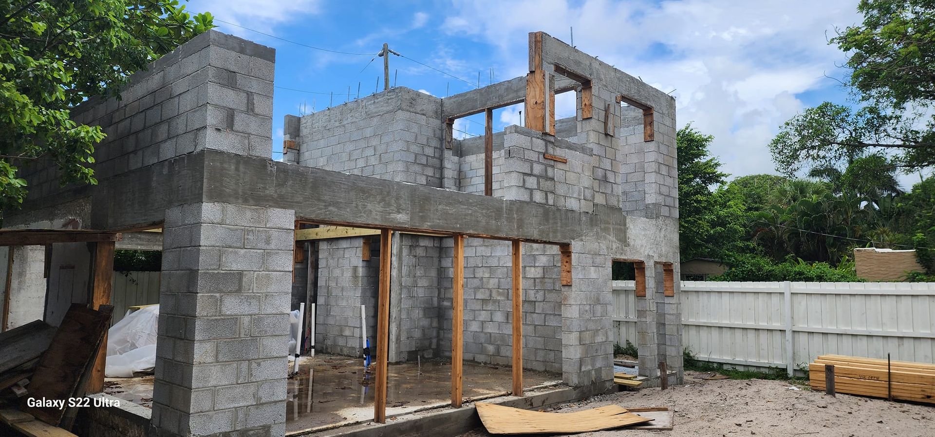 A house is being built with bricks and wooden beams.