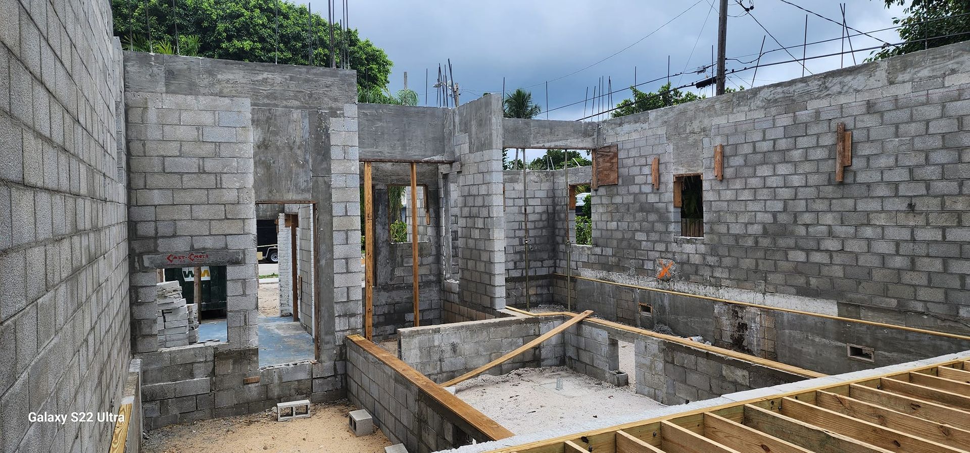 A house is being built with bricks and wooden beams.