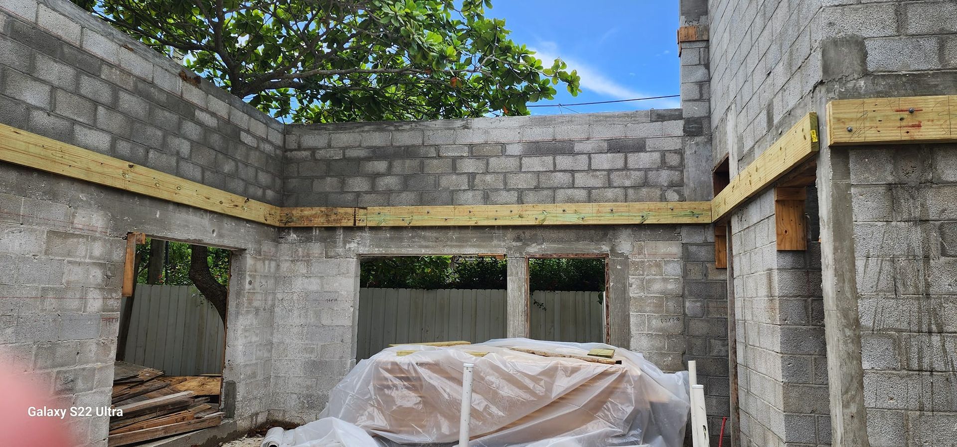 A house is being built with bricks and wooden beams.