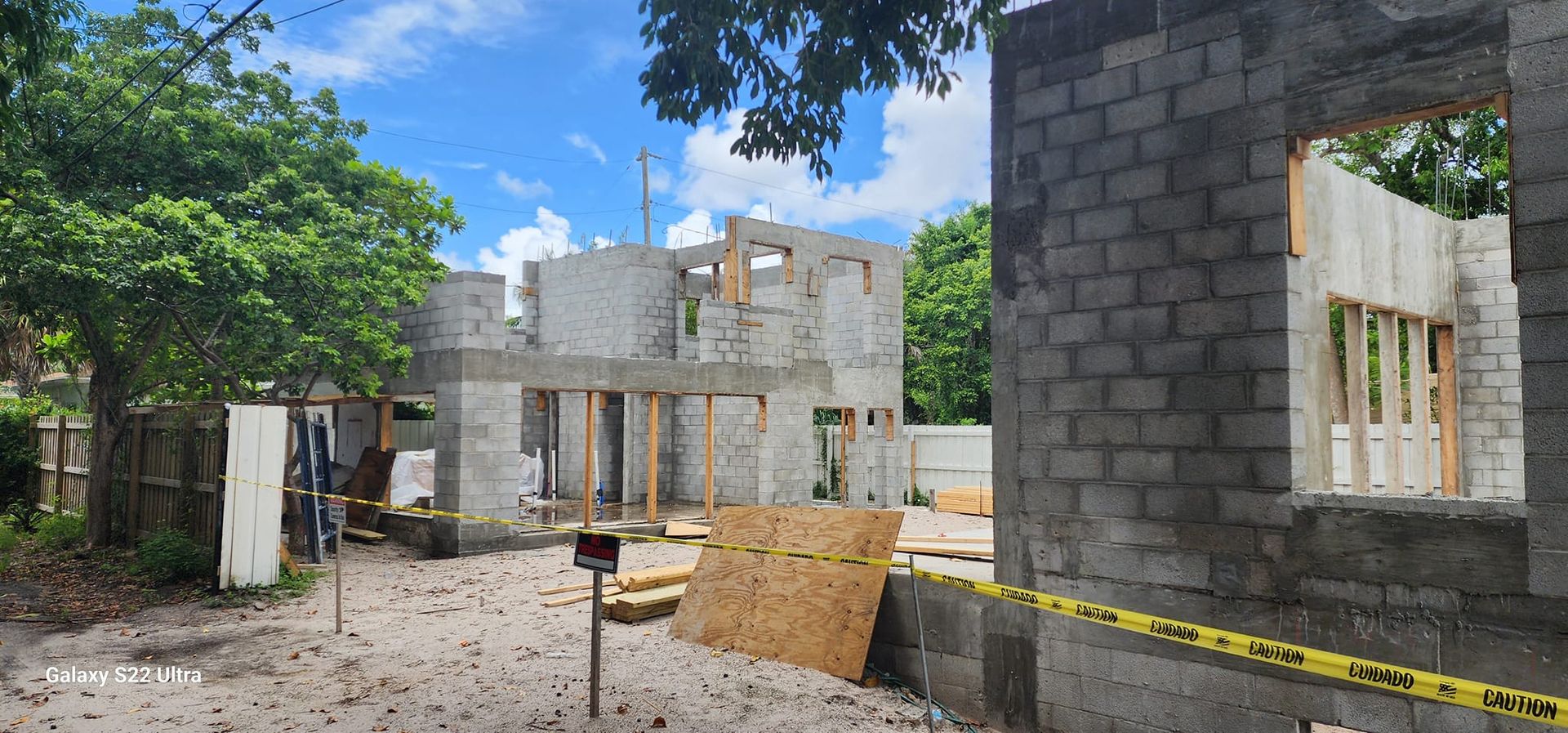 A house is being built in the middle of a dirt field.