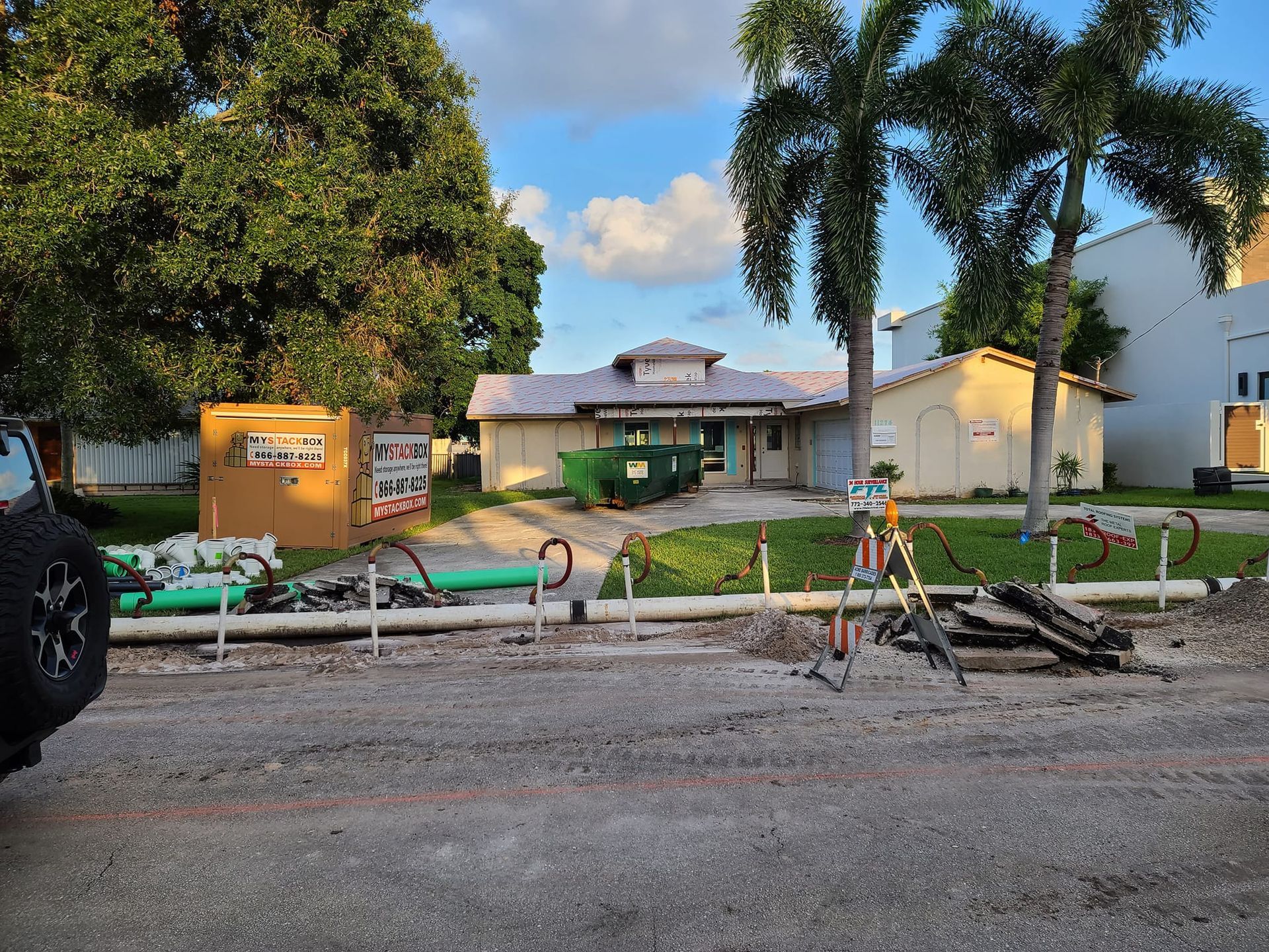 A construction site with a house in the background