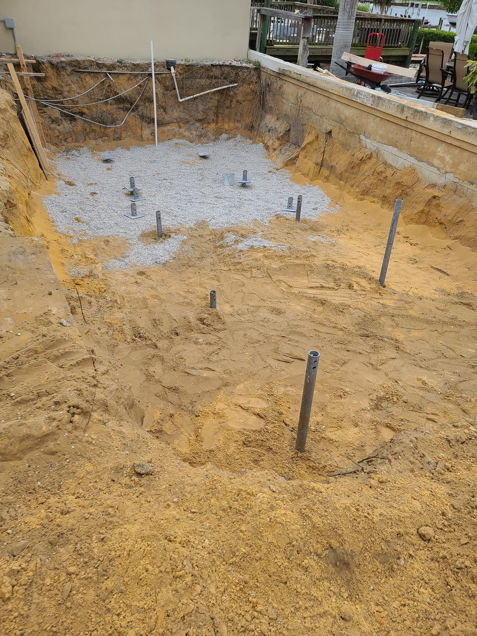 A large pile of dirt and gravel is being built in front of a building.