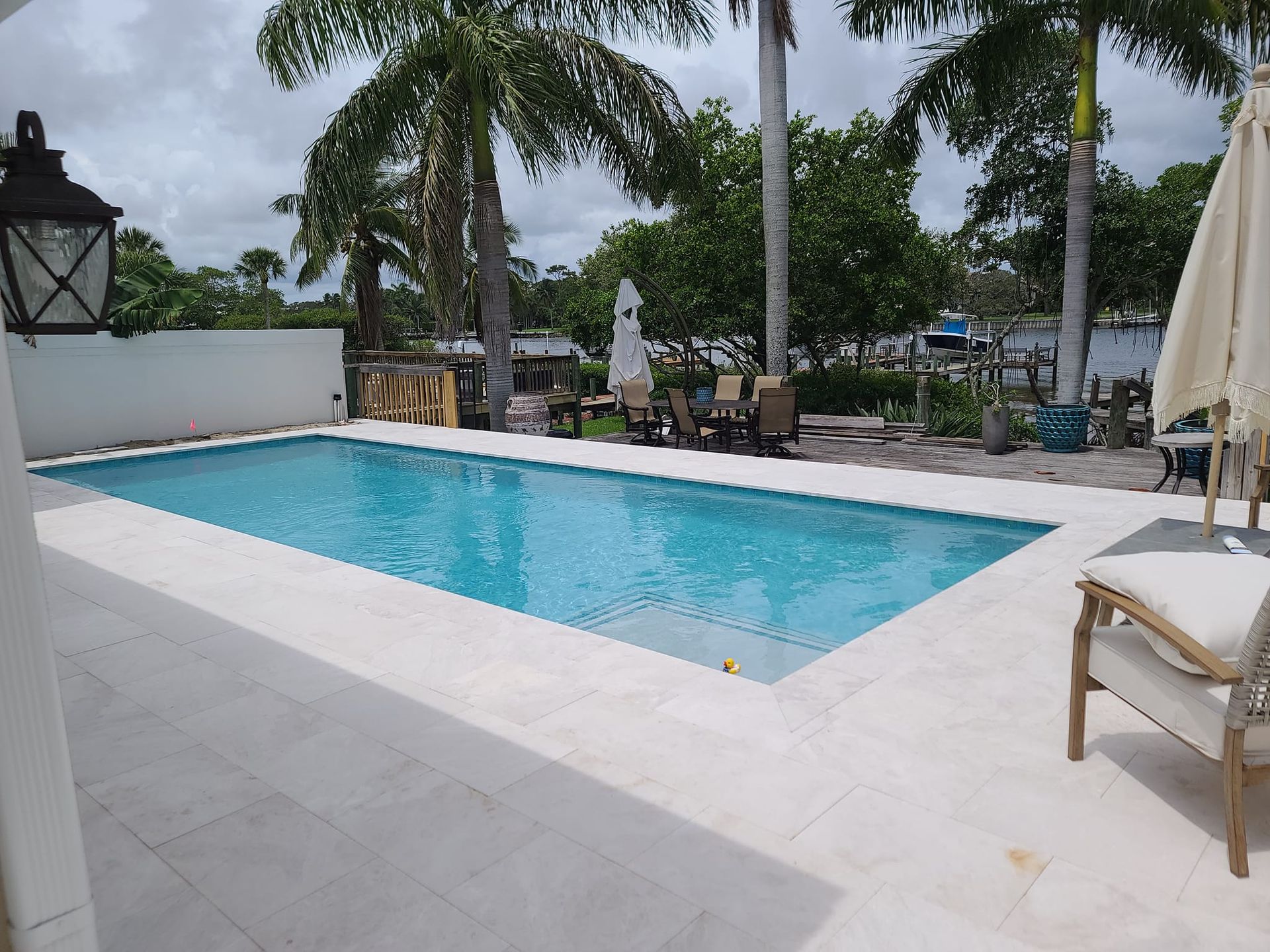 A large swimming pool with palm trees in the background