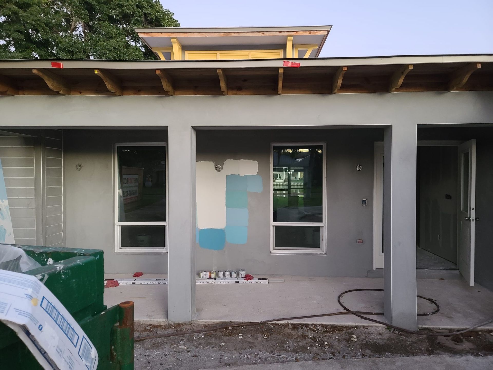 A house with a lot of windows is being painted