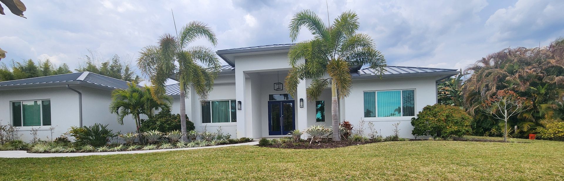 A group of men are working on the roof of a house.
