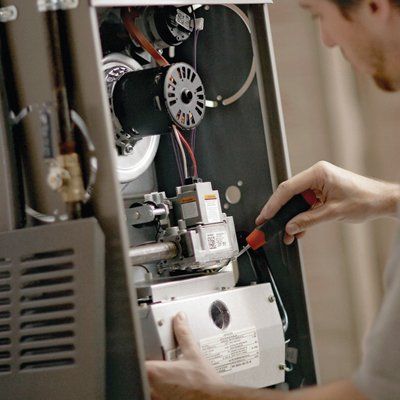 Man Repairing HVAC — Berlin, NJ — B & B Air Conditioning & Heating, Inc.