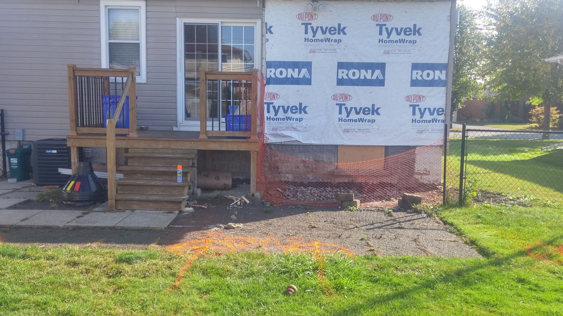 A house is being remodeled with a deck and stairs.