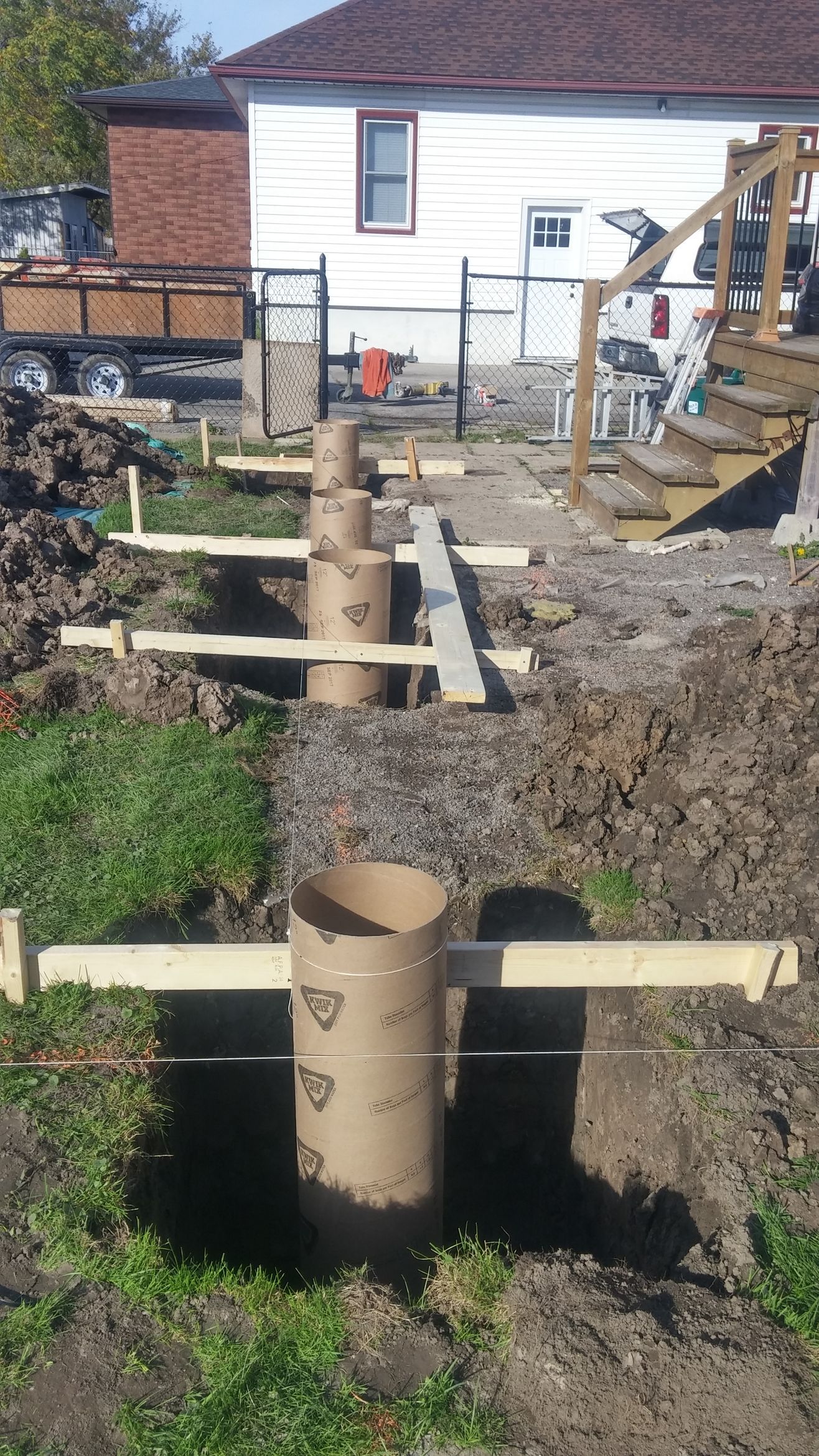 A construction site with a house in the background.