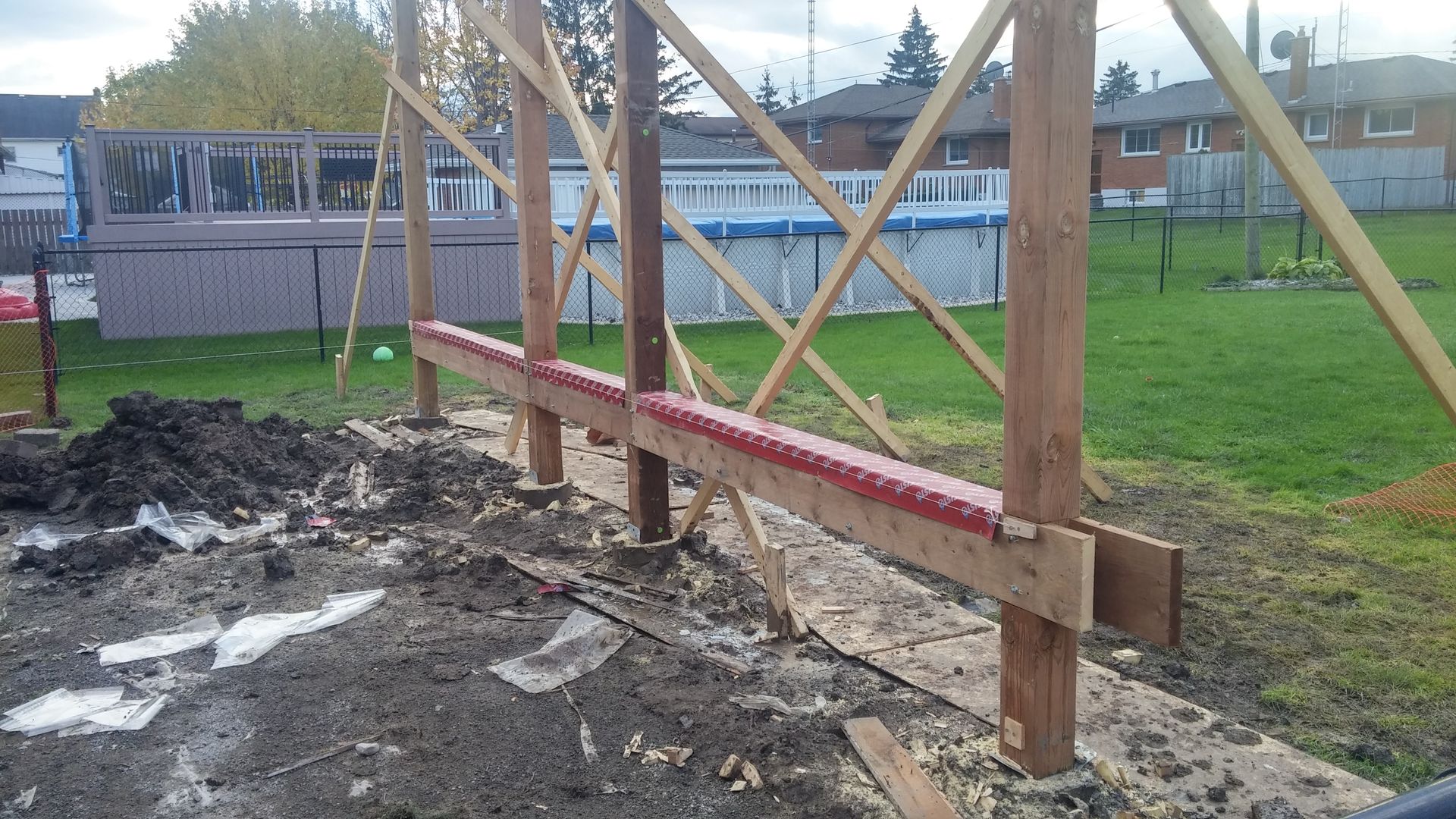A wooden structure is being built in a field