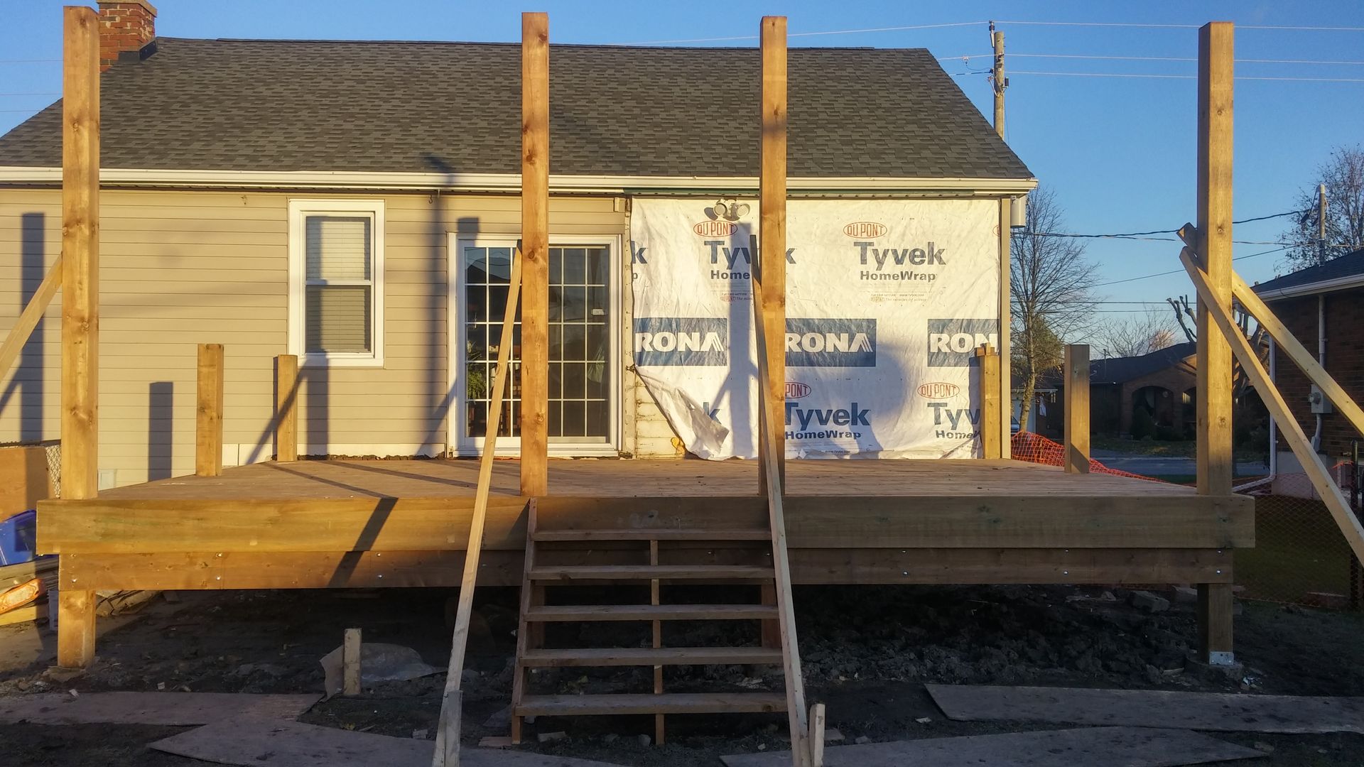 A house with a wooden deck in front of it