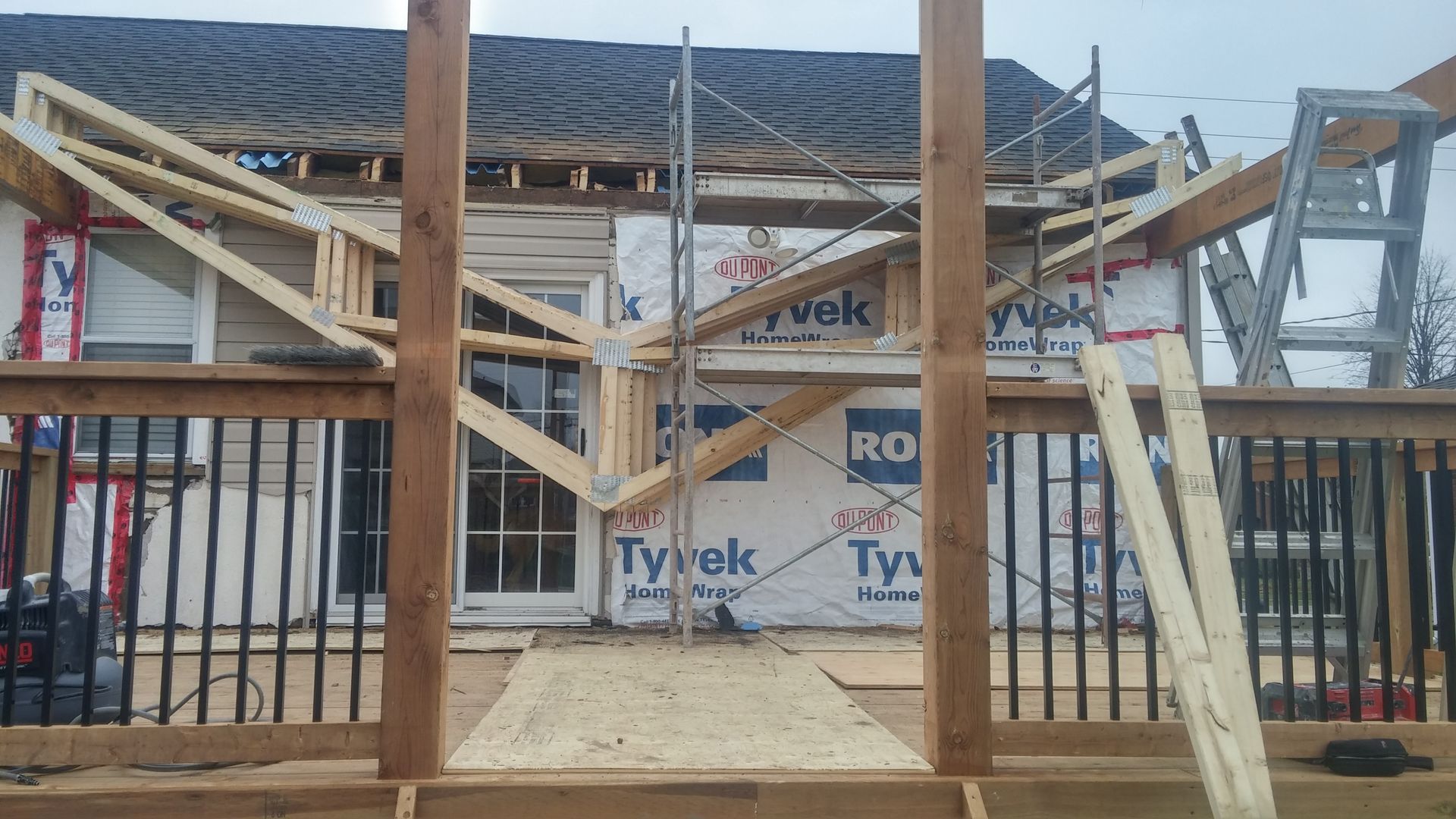 A house is being built with wooden beams and scaffolding.
