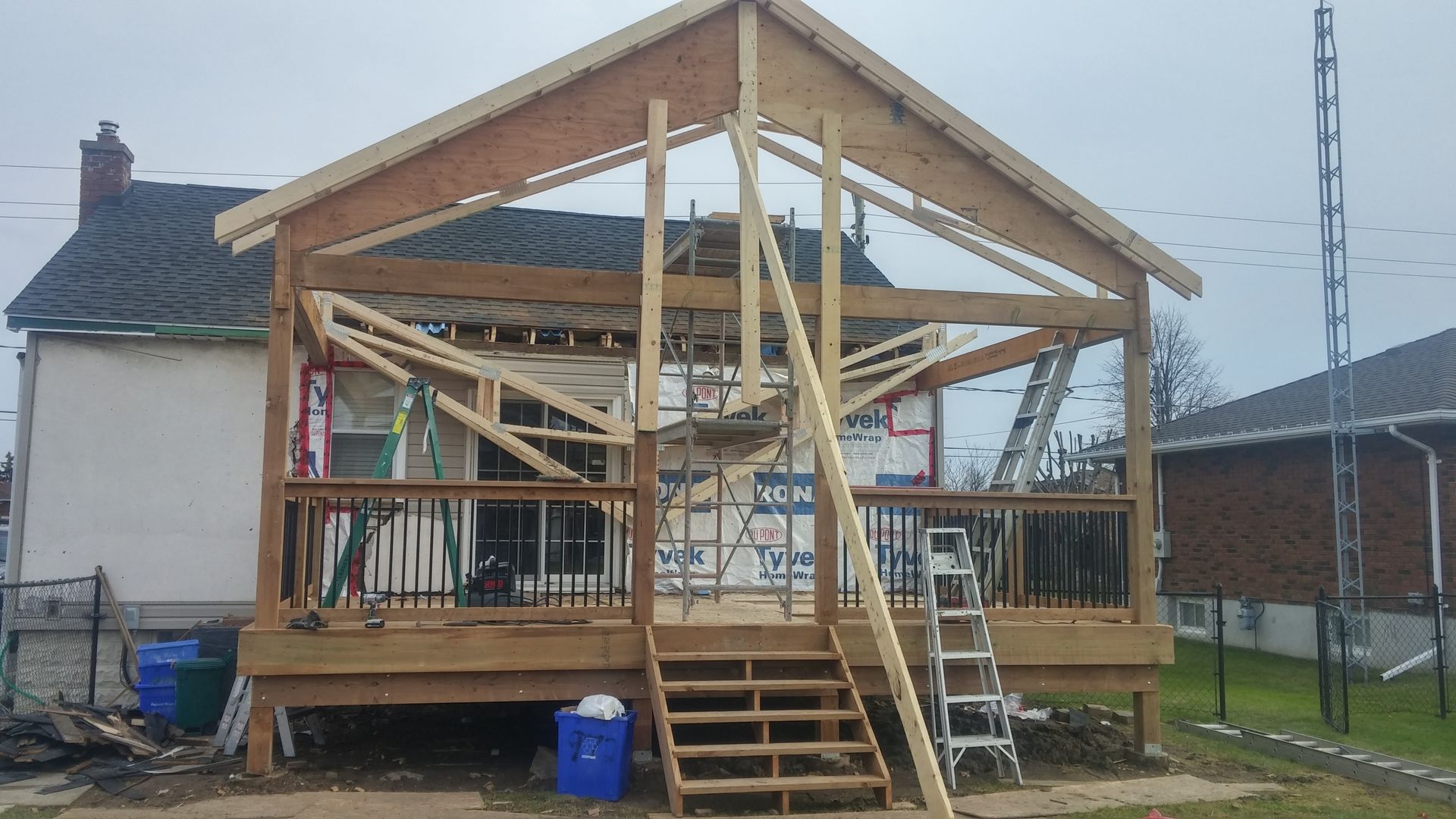 A house is being built with a wooden deck and stairs.