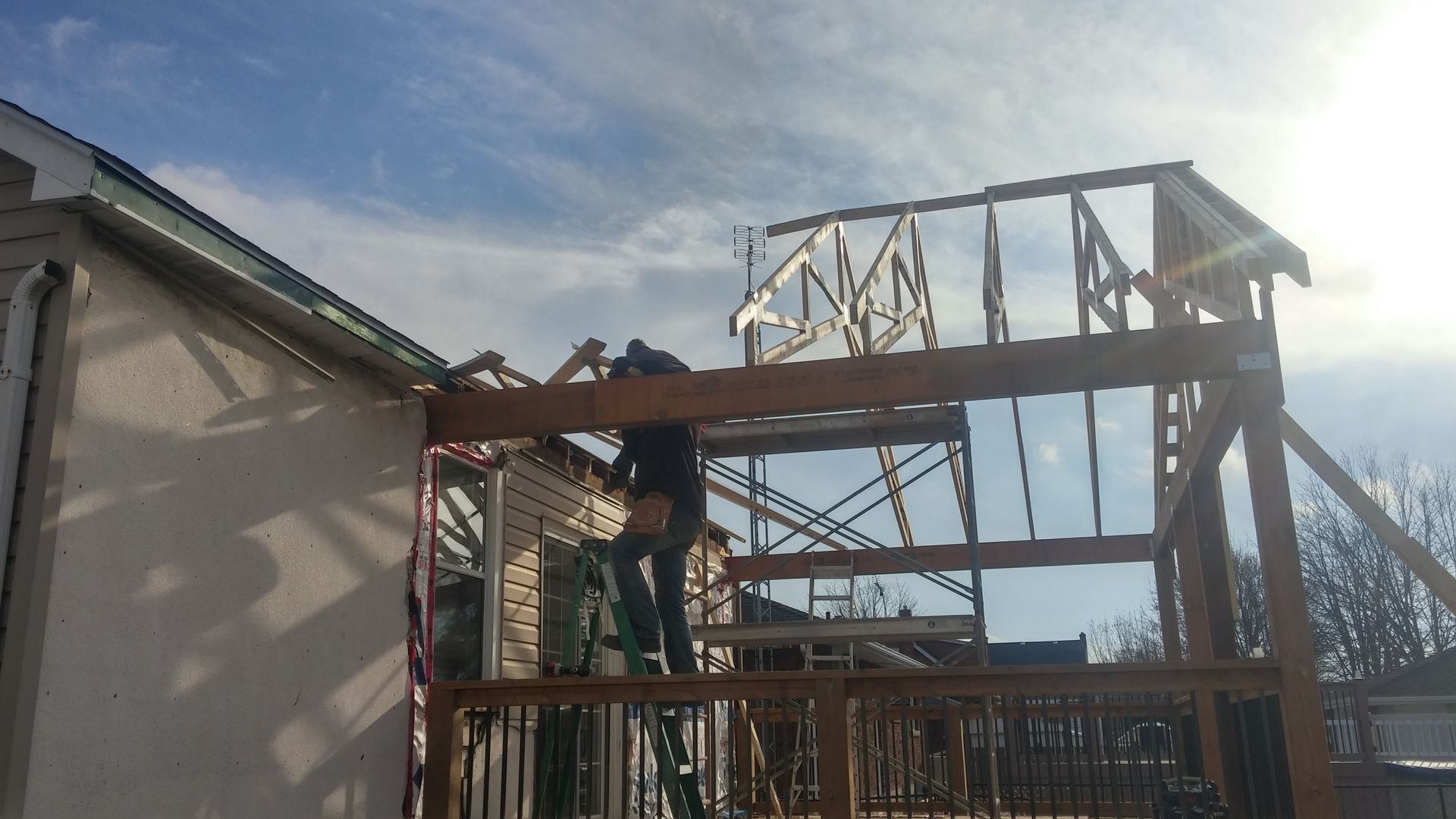 A man is working on the roof of a building