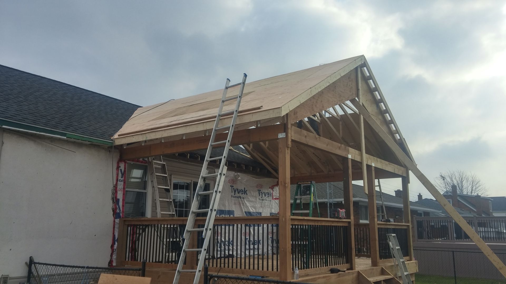 A ladder is sitting on top of a wooden structure under construction.