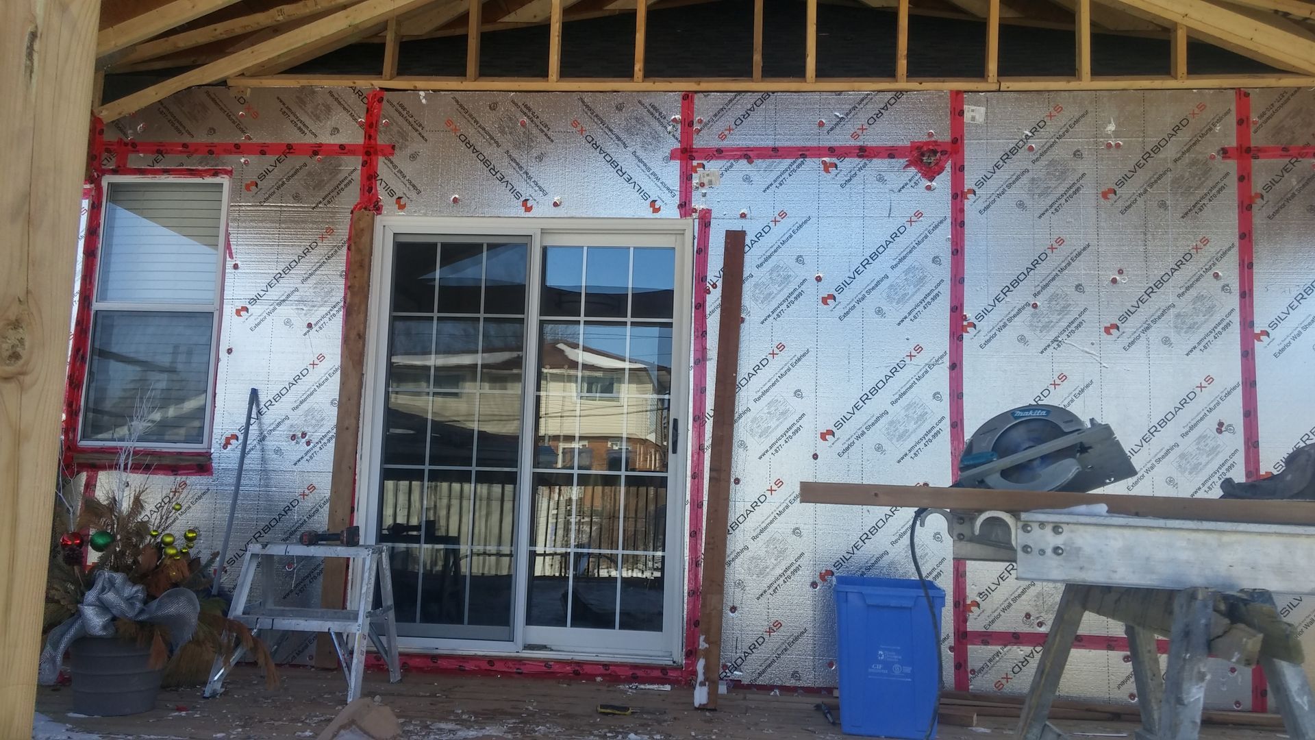A house with a sliding glass door is being built.