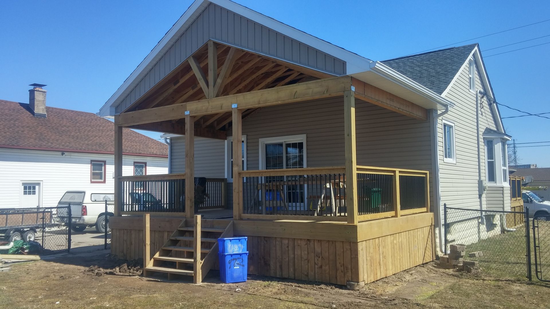 A small house with a wooden deck and stairs
