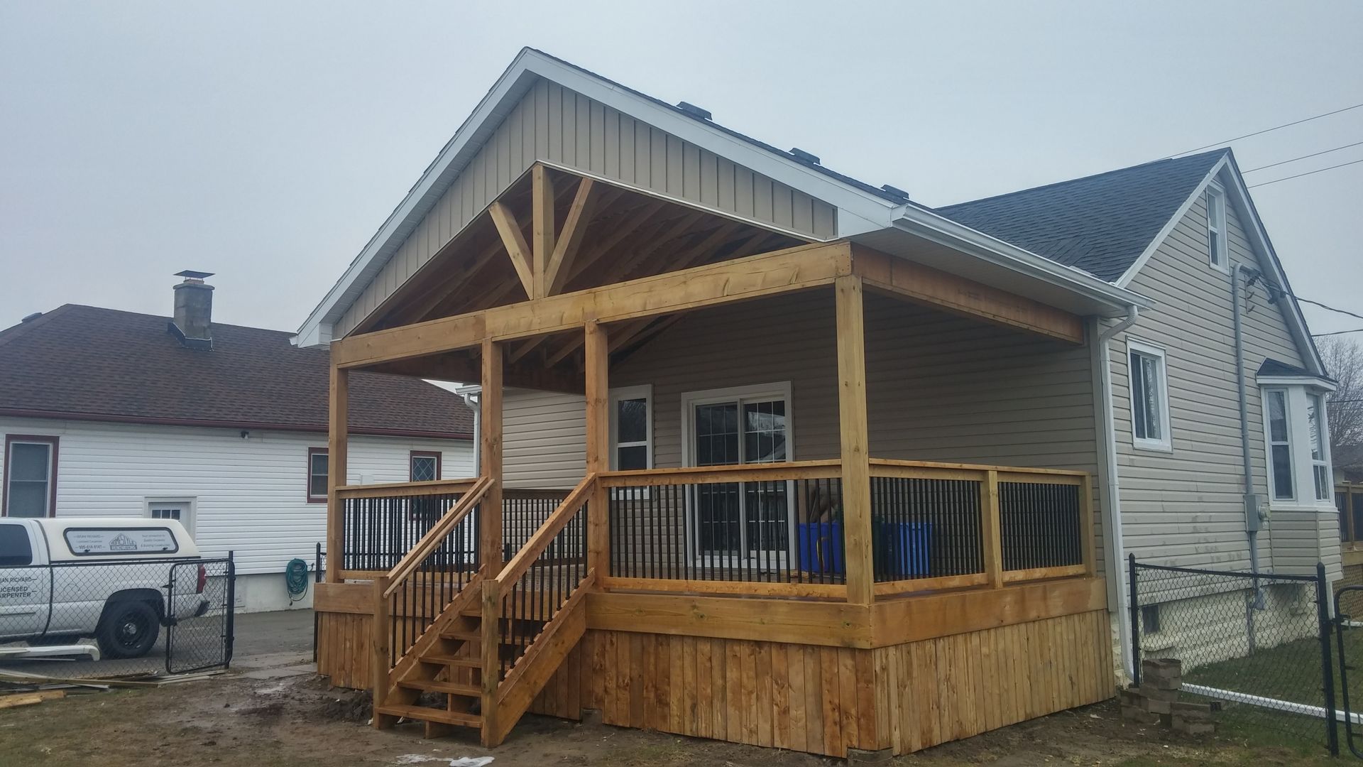A house with a wooden deck and stairs in front of it
