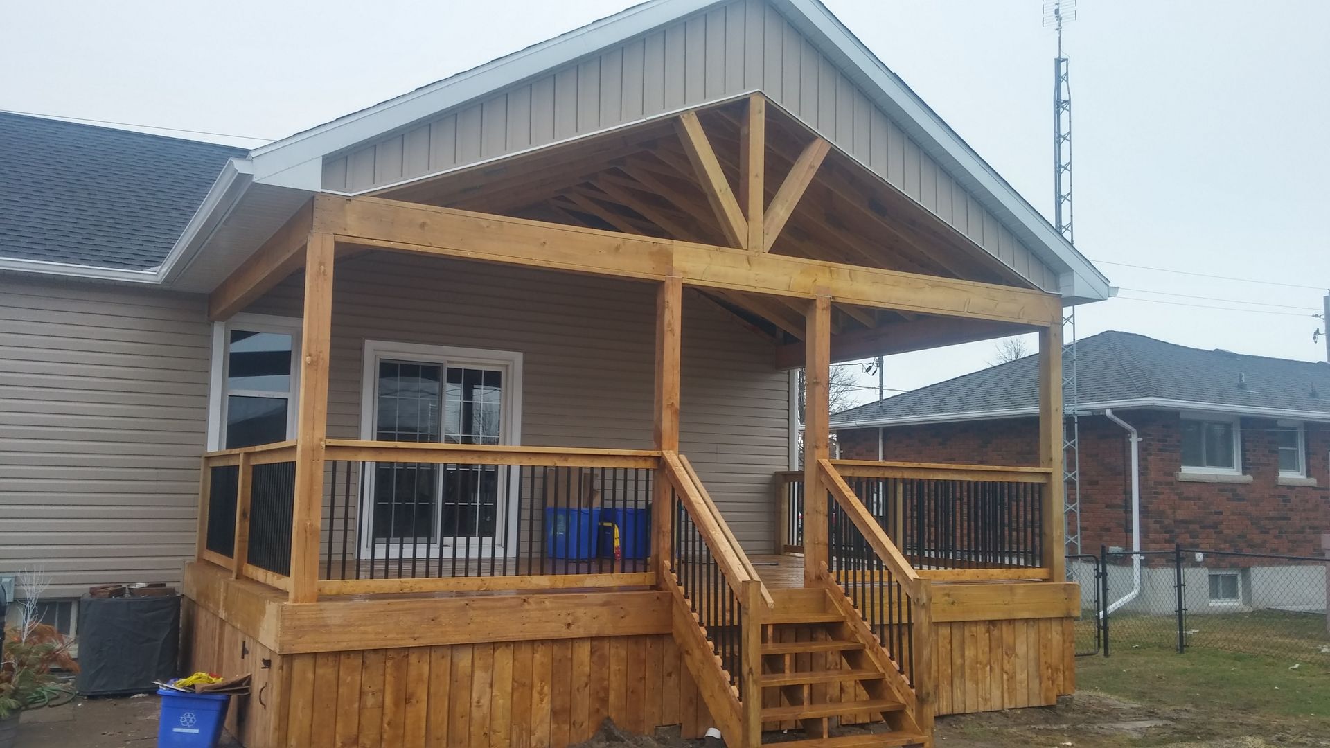 A house with a wooden deck and stairs in front of it