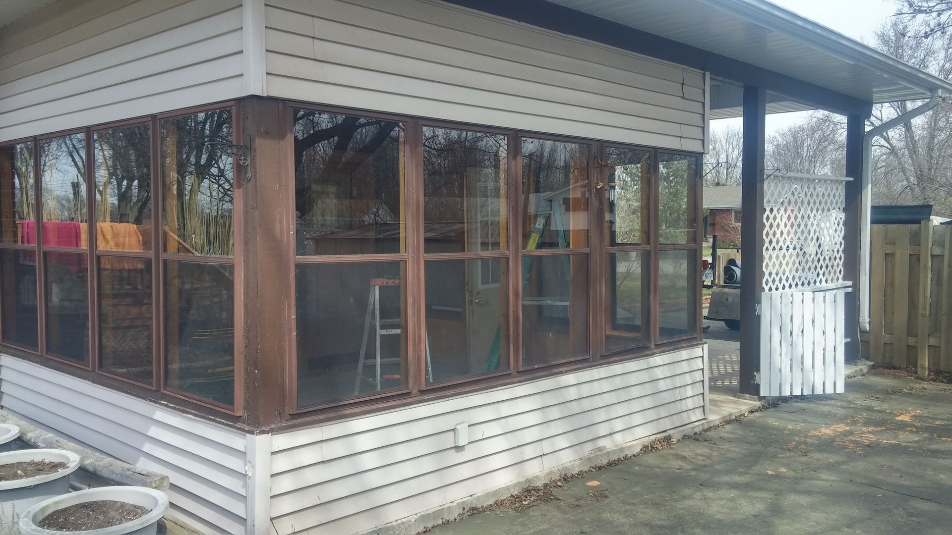 A house with a screened in porch and a lot of windows.