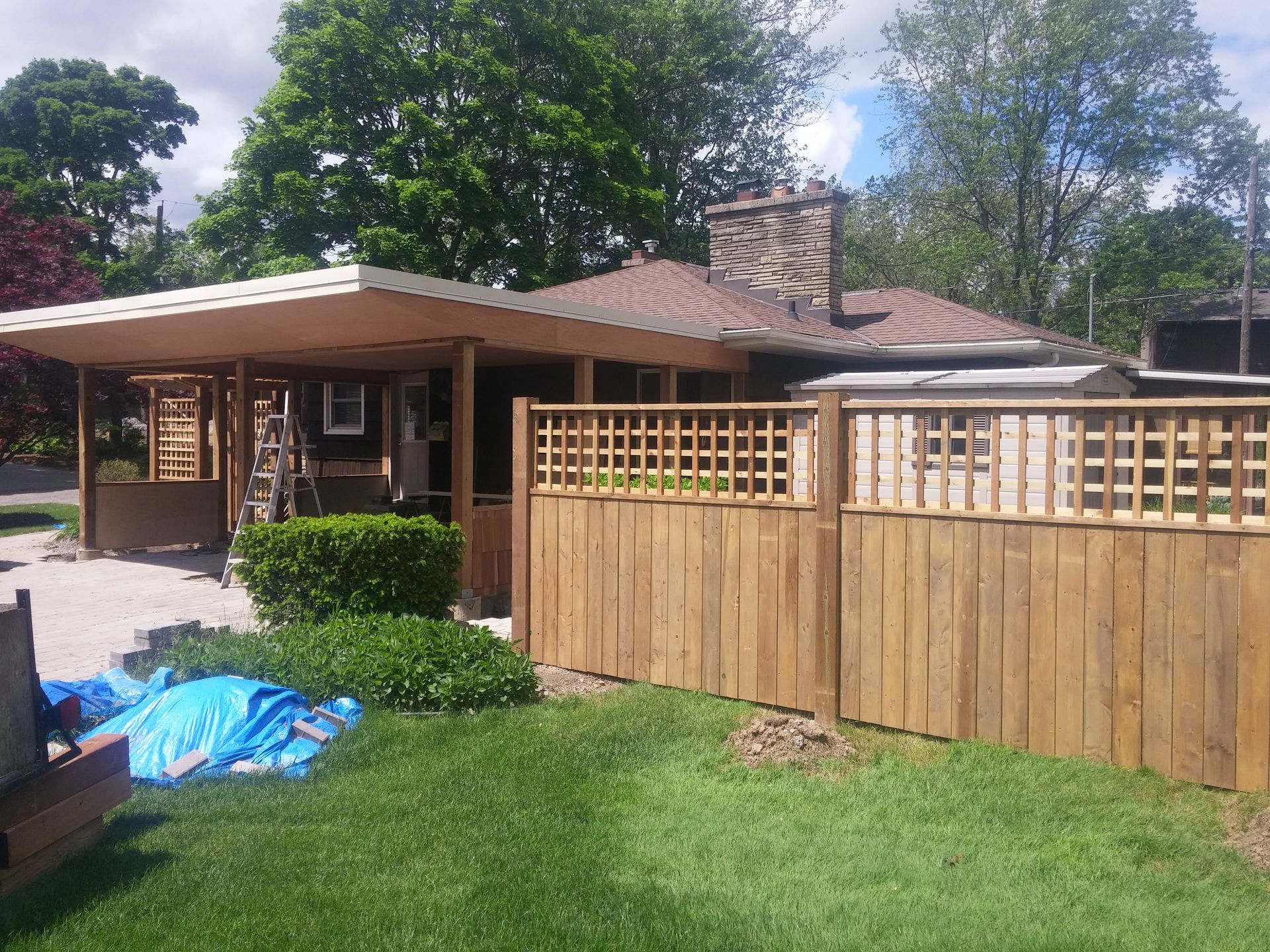 A house with a wooden fence in front of it
