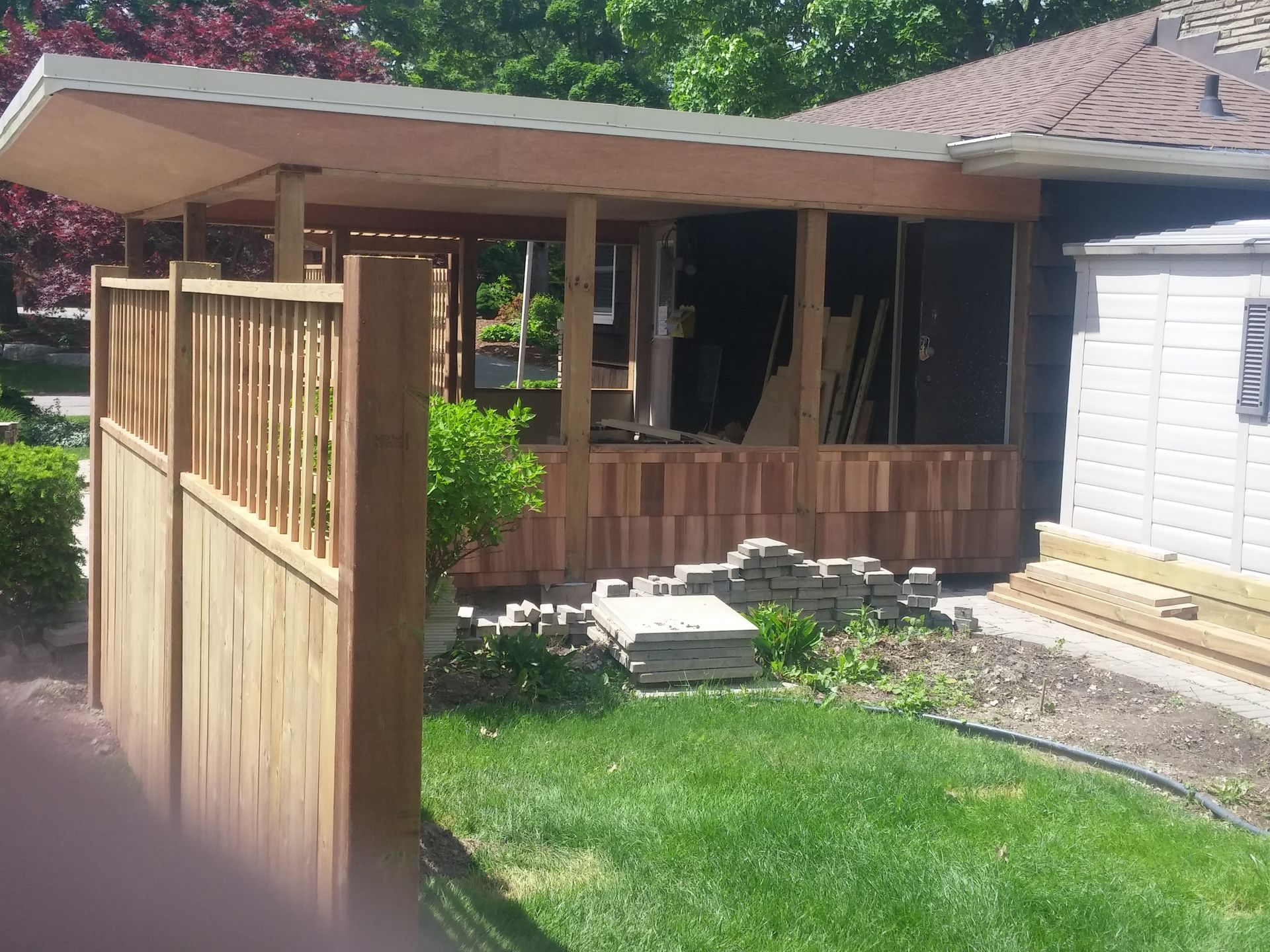 A house under construction with a wooden fence in front of it